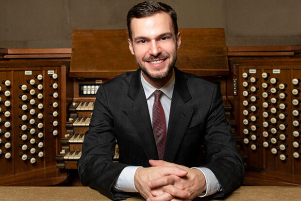 Organist Nathan Laube in front of organ