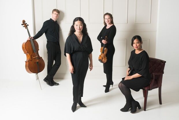 The Villiers Quartet in black clothes stood against cream background