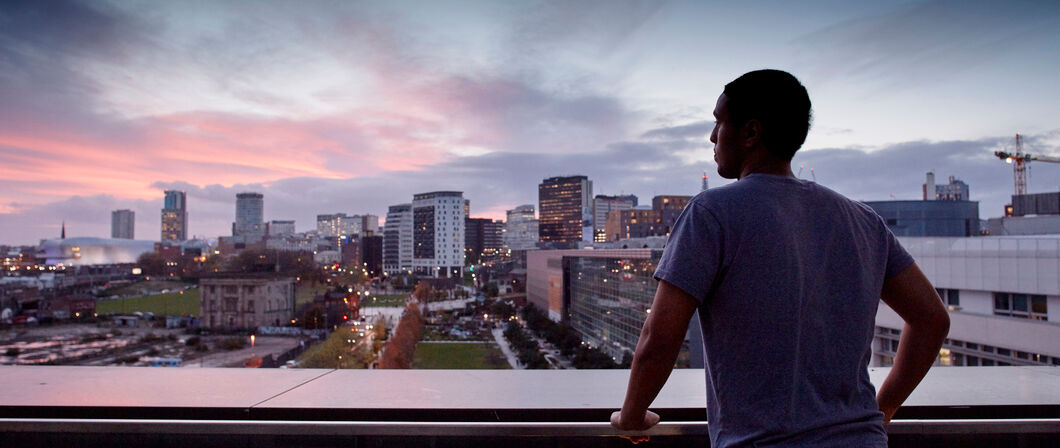 Photo of person looking out across Birmingham from Curzon balcony.