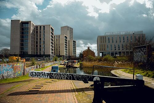 External photo of University Locks accommodation and surrounding canals on a sunny day