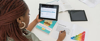 MSc Accounting and Finance Image 341x139 - Woman sat at desk with a tablet and accounting books