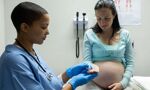 Medical professional monitoring pregnant woman