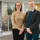 BCU's Jenny Harding and Professor Oliver Carter pictured next to a research degrees banner on securing a Doctoral Landscape Award from the AHRC