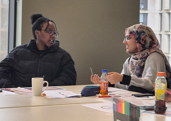 Student mentors a young person in classroom