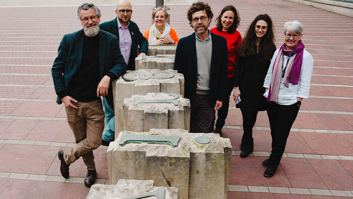 Group of researchers with typeface sculpture