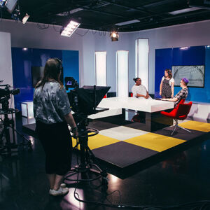 Students in Studio D newsroom set