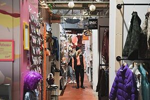 A student browses a variety of products in a vintage clothing store