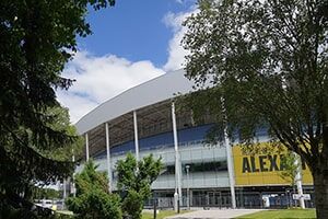 An external photo of the Alexander Stadium with surrounding trees