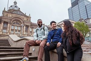 Students enjoying the city sitting on the steps in Victoria city square