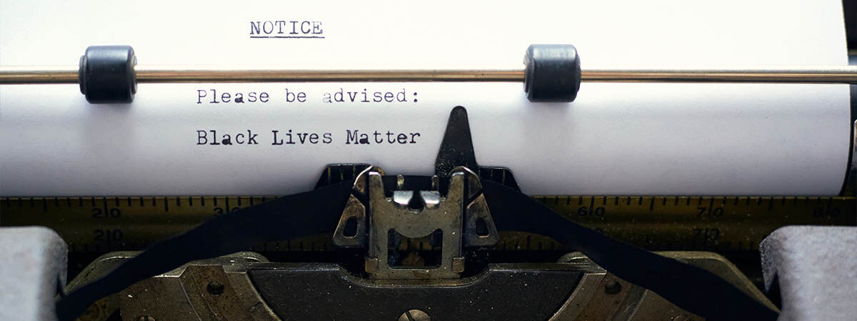 BLM Books 1200x450 - Typewriter with the words "Please be advised - Black Lives Matter"