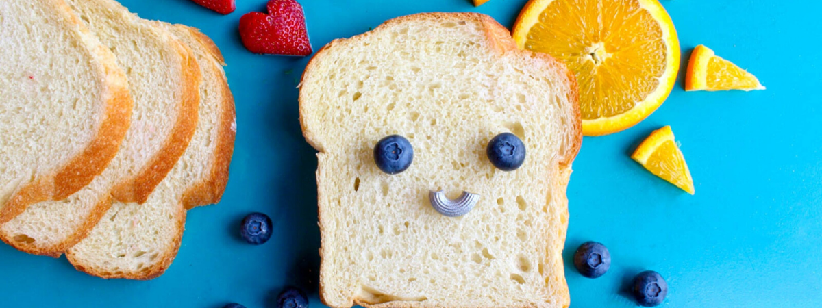 Bread and fruit making a smiling face
