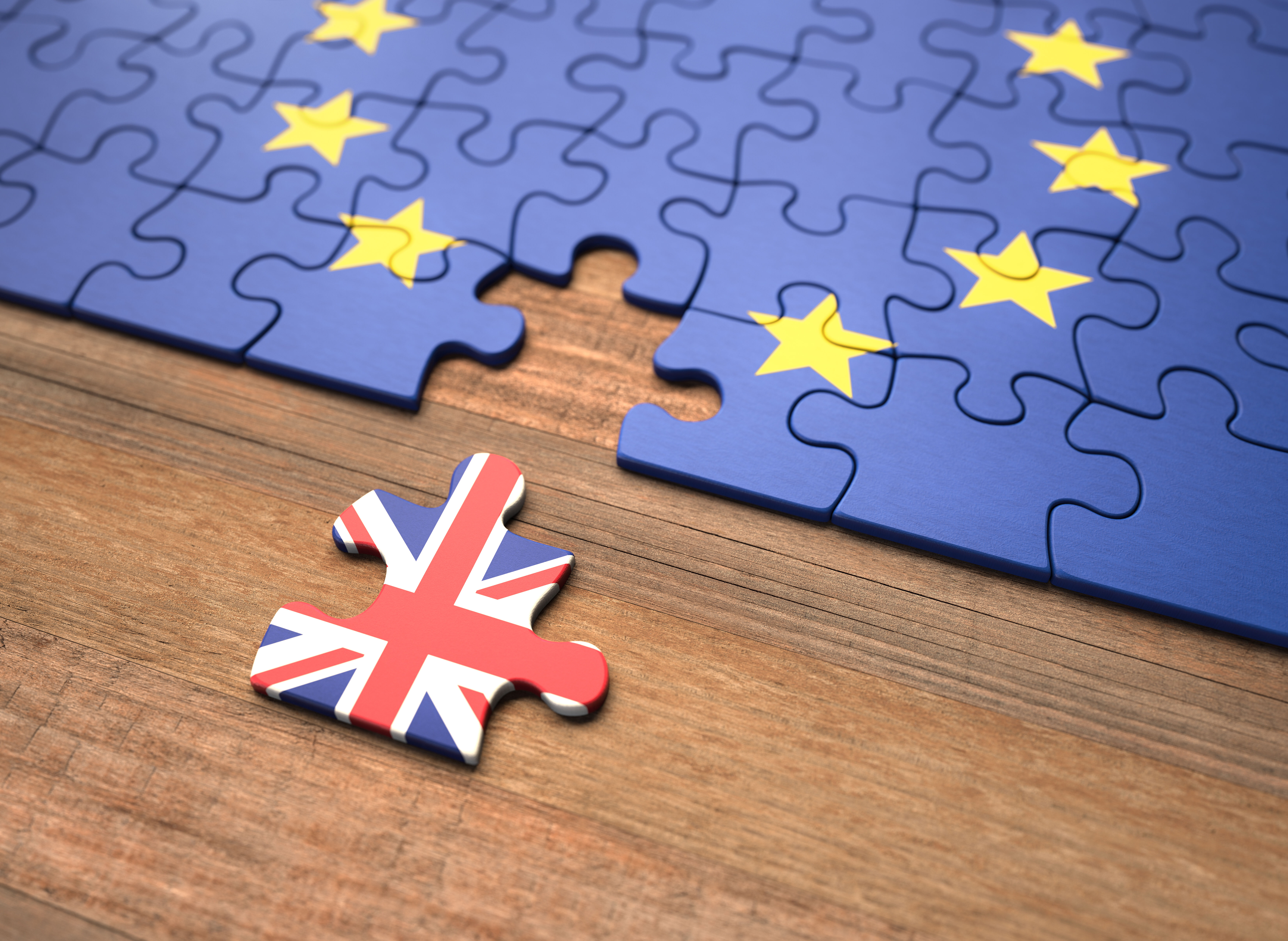 Depiction of Brexit with Union Jack puzzle piece separated from European Union 