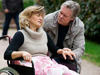 Care worker attends to woman in wheelchair