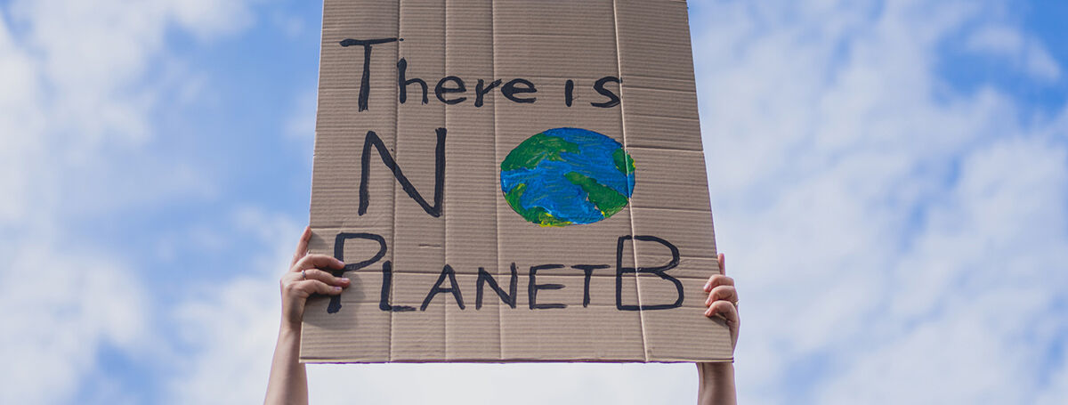 Climate change protestor with a sign saying 'No Planet B'