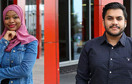 Two construction students stood outside of the Curzon building