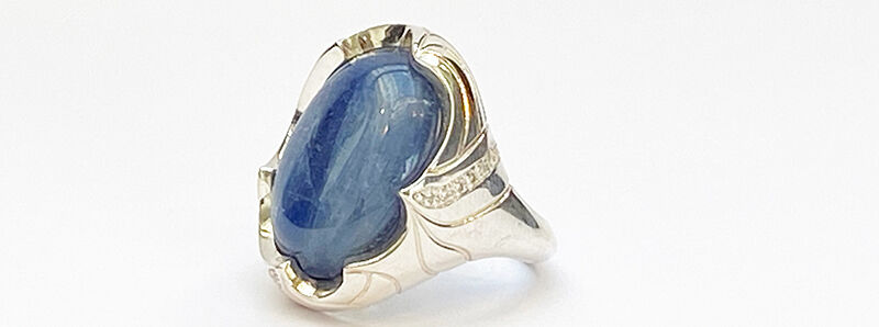 Close up of ring with large blue gemstone