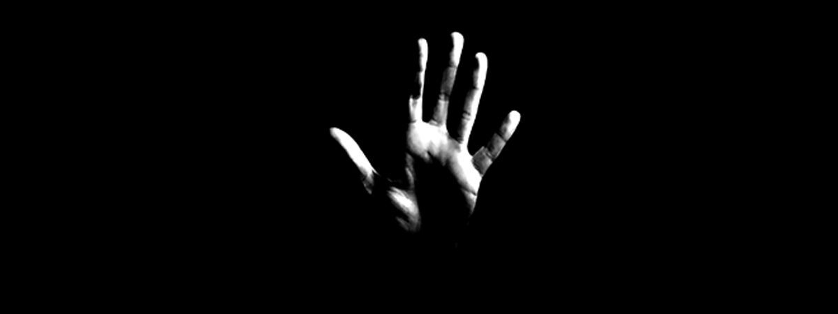 Domestic Abuse Liz Yardley Blog 1200x450 - Hand against a black backdrop