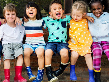 Early Social Environment Image 350x263 - Kids sat on a wall