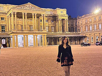 Emaleigh Conn stood outside Buckingham Palace at night