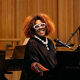 Errollyn Wallen playing piano and smiling