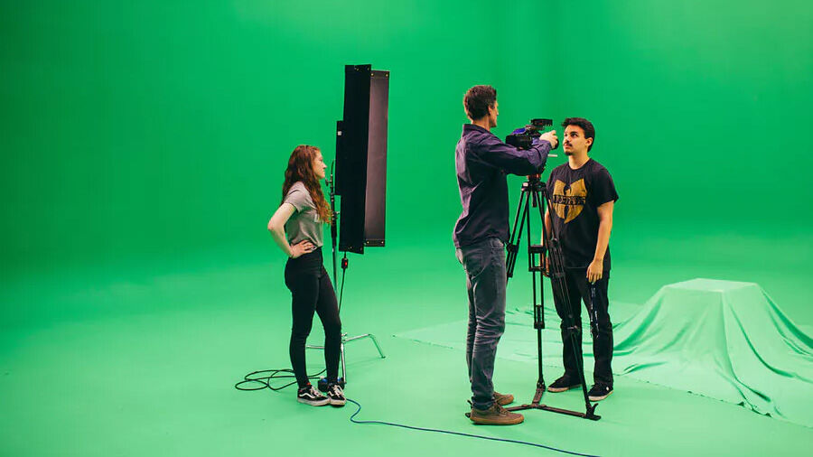 Film students filming in front of a green screen