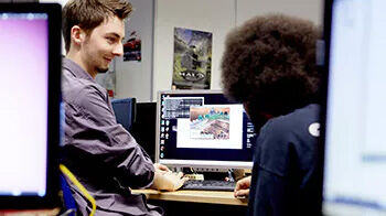 Gaming students sitting round a computer