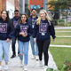 Group of students wearing I am BCU hoodies, walking at City Centre campus