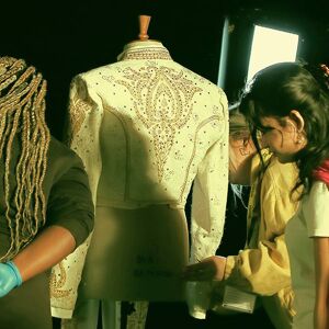 Students placing outfit onto mannequin 