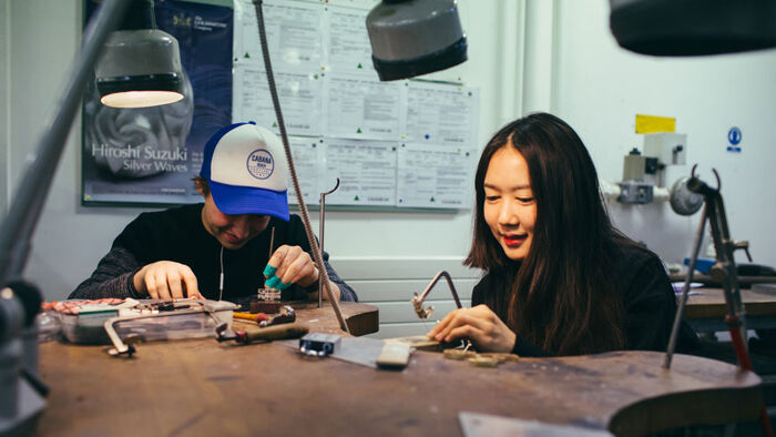 Two students work in a jewellery workshop