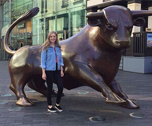 Katie Bollard Three Favourite Things Image 3 300x250 - Katie standing next to the Bull statue