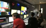 A group of people within the control room for a TV studio
