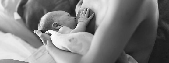 Mother breastfeeds her newborn baby