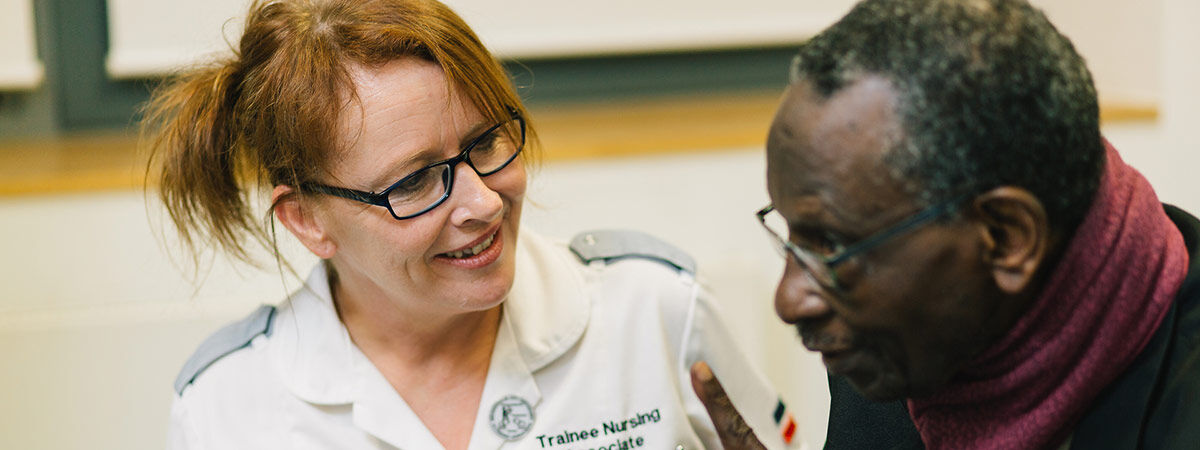 nursing associate student with a patient