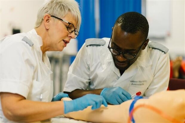 Two Nursing students working on dummy