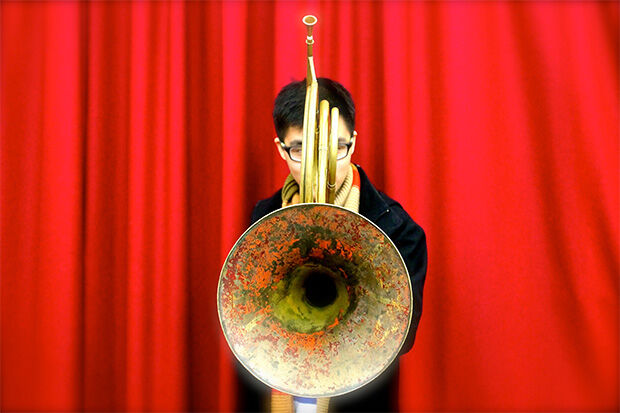 Natural horn player Isaac Shieh, hiding behind his horn