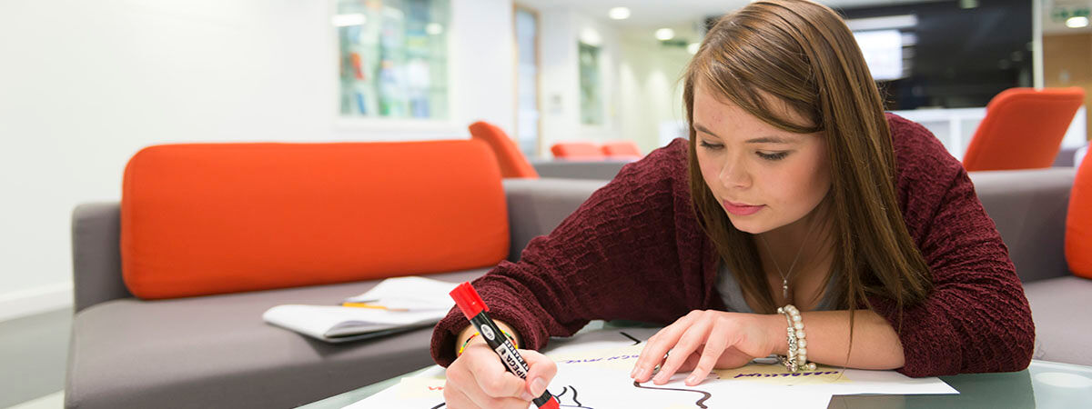 Student drawing with a marker pen