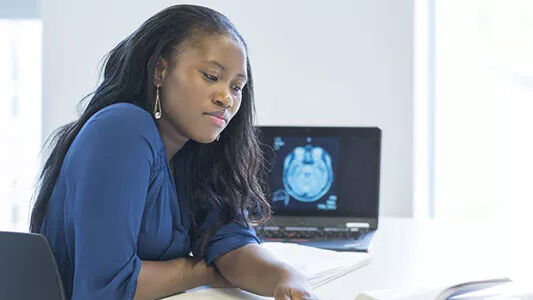 Psychology student with laptop and books