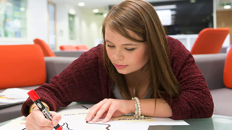 Student drawing with a marker pen