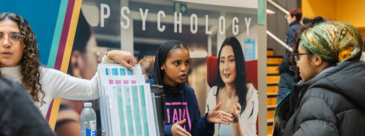 Student talking to visitor at an open day