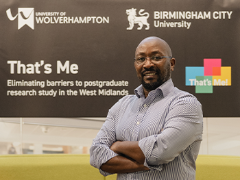 Portrait of male in front of the That's Me! research project banner to promote the social campaign launch February 2025