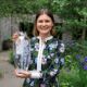 Ula Maria holding her engraved vase for the Best in Show award at the RHS Chelsea Flower Show