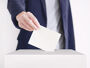 Voter casting ballot paper