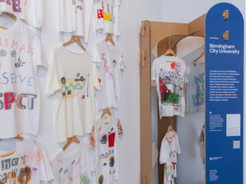  A vibrant display of various t-shirts arranged on a wall, showcasing different colors and designs. They have slogans about animal rights on them.